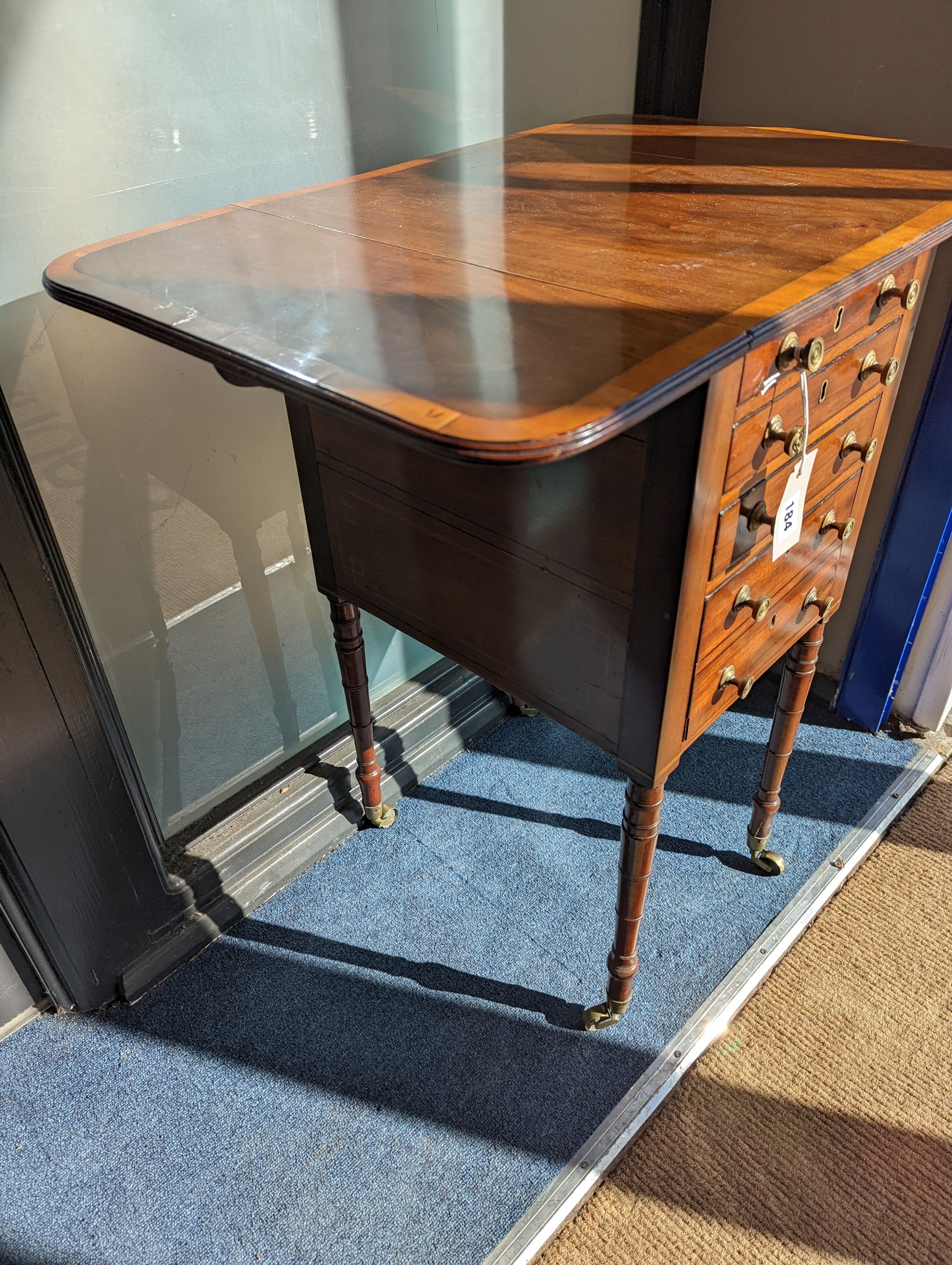 A Regency satinwood banded mahogany drop flap work table, width 69cm extended, depth 46cm, height 76cm